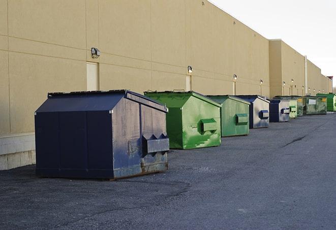 construction crew disposing of building materials in large bins in Arlington, MA